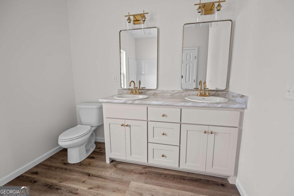 96 Beech Road Hazlehurst, GA 31539 - Photo 24 of 32 a bathroom with a toilet sink and mirror