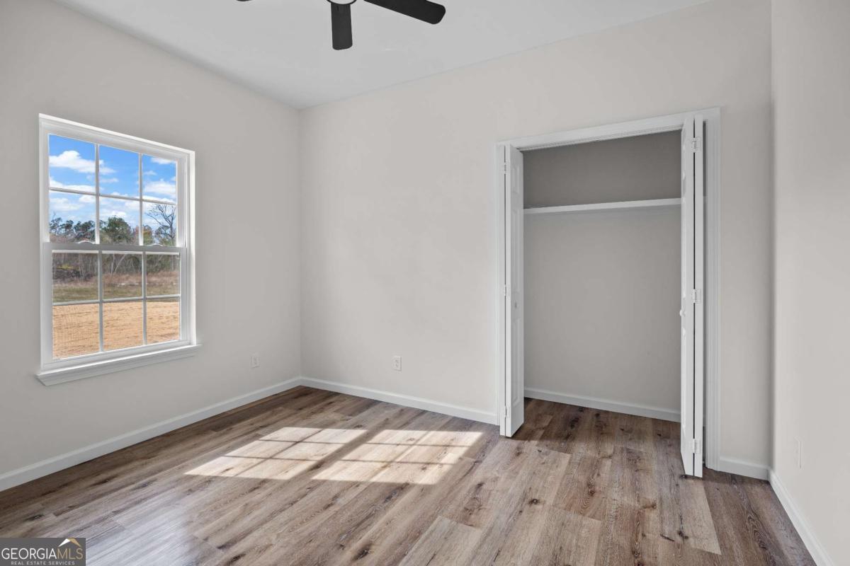 96 Beech Road Hazlehurst, GA 31539 - Photo 32 of 32 wooden floor in an empty room with a window