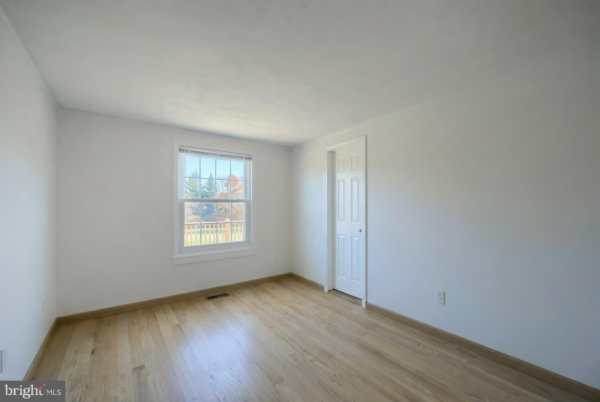 2 Dutton Road New Freedom, PA 17349 - Photo 16 of 39 a view of an empty room with wooden floor and window