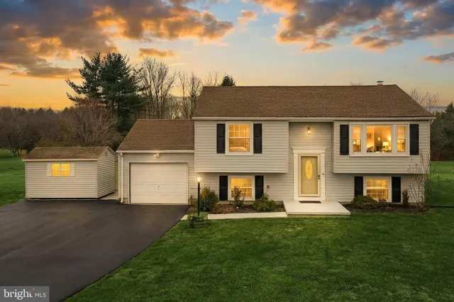 a front view of a house with a yard and a garage