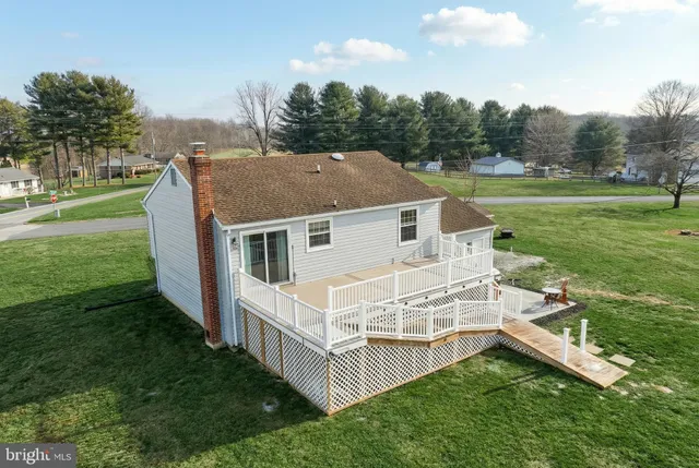 a aerial view of a house with a yard table and chairs