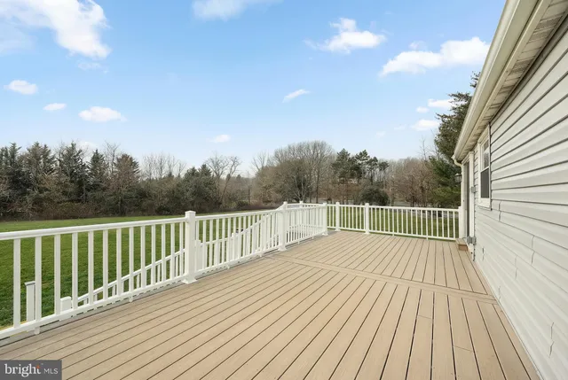 a view of a balcony with wooden floor and fence