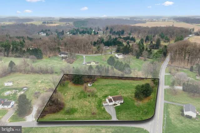 an aerial view of a residential houses with outdoor space