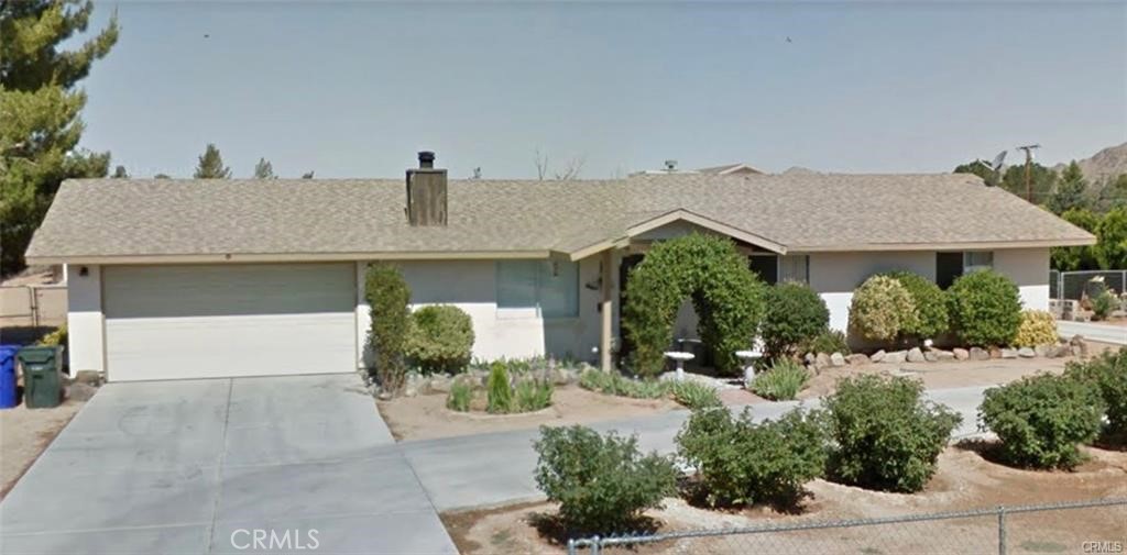 15220 Erie Road Apple Valley, CA 92307 - Photo 1 of 1 a front view of a house with garden