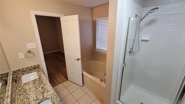 a bathroom with a shower and a sink