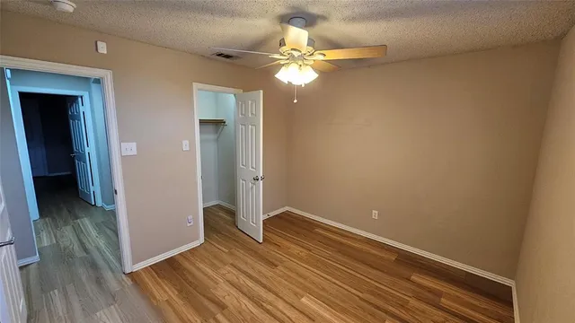 a view of a room with wooden floor