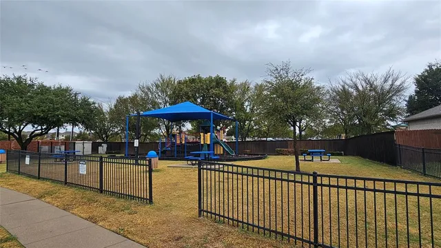 a view of a park with iron fence
