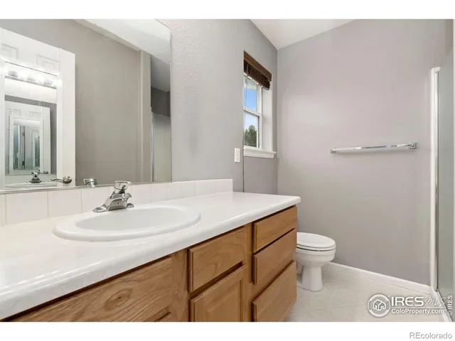 a bathroom with a sink toilet and mirror