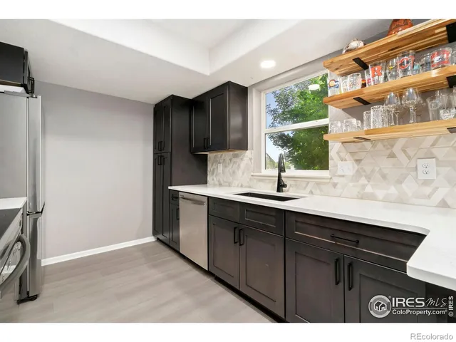 a kitchen with a sink cabinets and a window