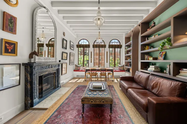 a living room with furniture a fireplace and a chandelier