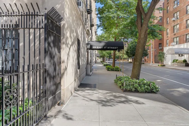 a view of path along with house and trees in the background