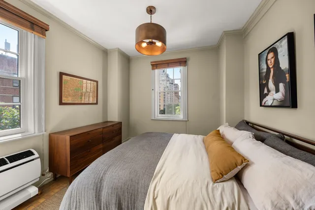 a bedroom with a bed and a chandelier