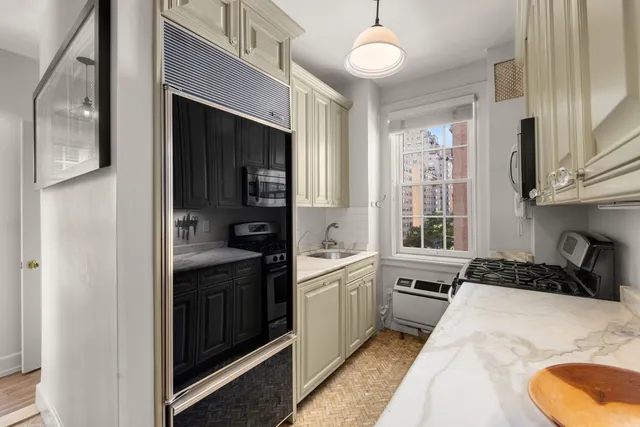 a kitchen with stainless steel appliances granite countertop a stove a sink and a refrigerator