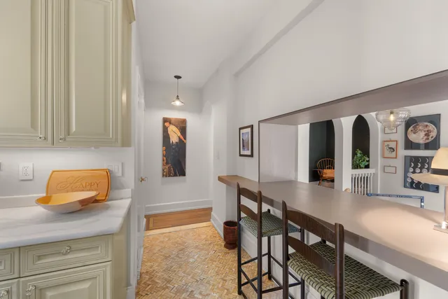 a hallway with dining table and chairs