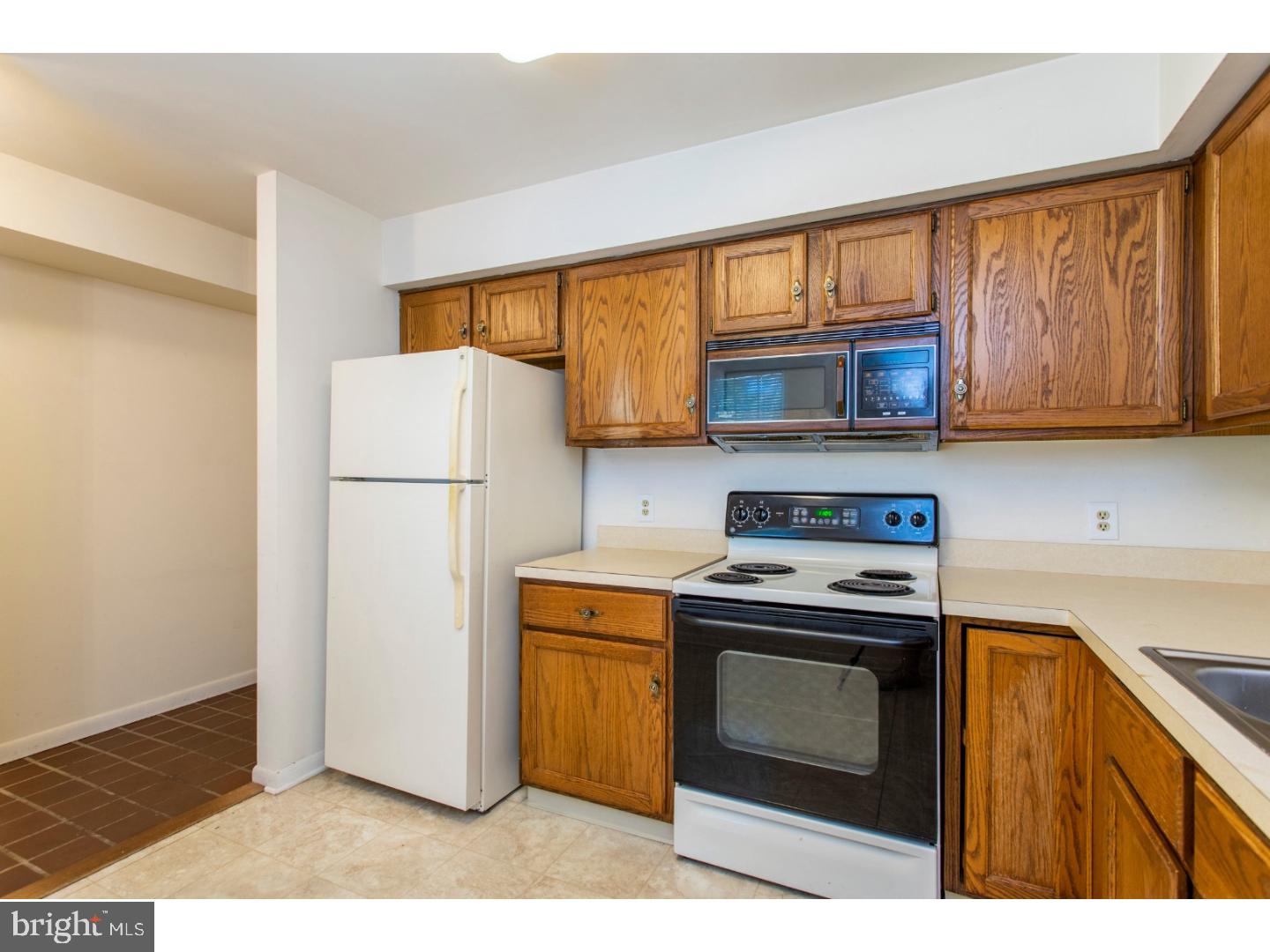 177 Valley Stream Lane Chesterbrook, PA 19087 - Photo 5 of 19 a kitchen with a stove a refrigerator and a microwave