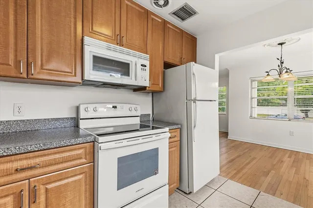 a kitchen with cabinets and steel stainless steel appliances