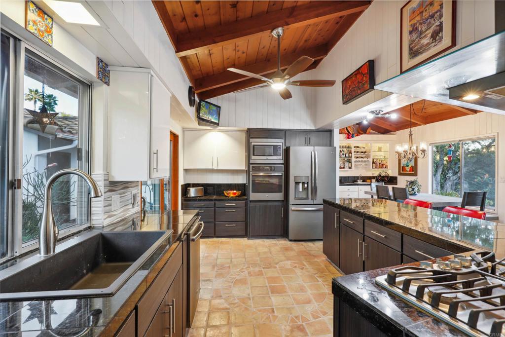826 Ora Avo Drive Vista, CA 92084 - Photo 11 of 52 a kitchen with stainless steel appliances granite countertop a sink and a stove