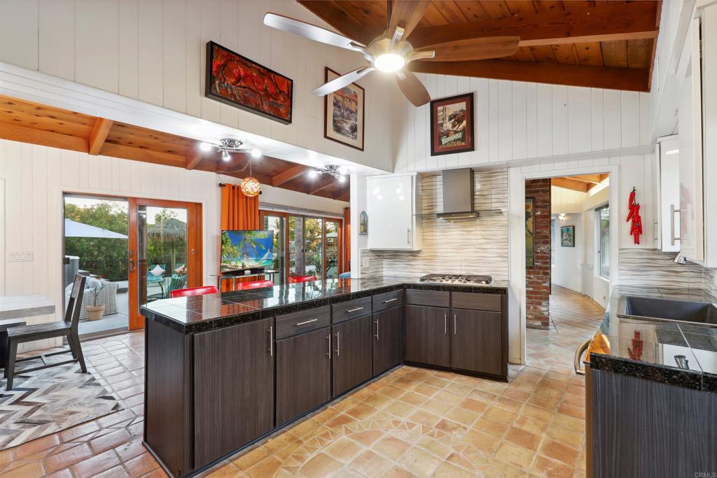 826 Ora Avo Drive Vista, CA 92084 - Photo 12 of 52 a kitchen with stainless steel appliances granite countertop a sink and wooden cabinets