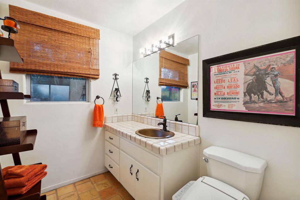 826 Ora Avo Drive Vista, CA 92084 - Photo 24 of 52 a bathroom with a toilet a sink and a mirror
