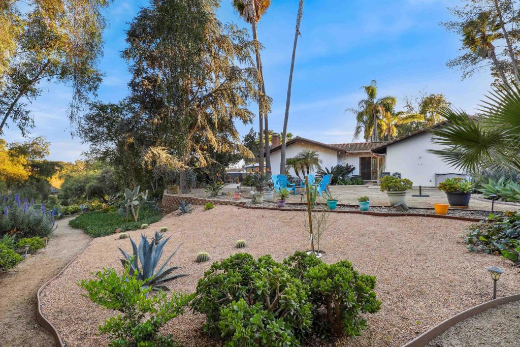 826 Ora Avo Drive Vista, CA 92084 - Photo 40 of 52 a view of a street with potted plants and a large tree