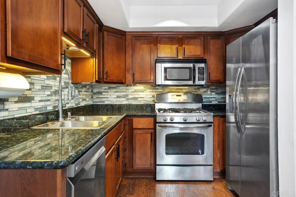 102 Sea Cliff Way Oceanside, CA 92056 - Photo 12 of 44 a kitchen with a stove sink and refrigerator