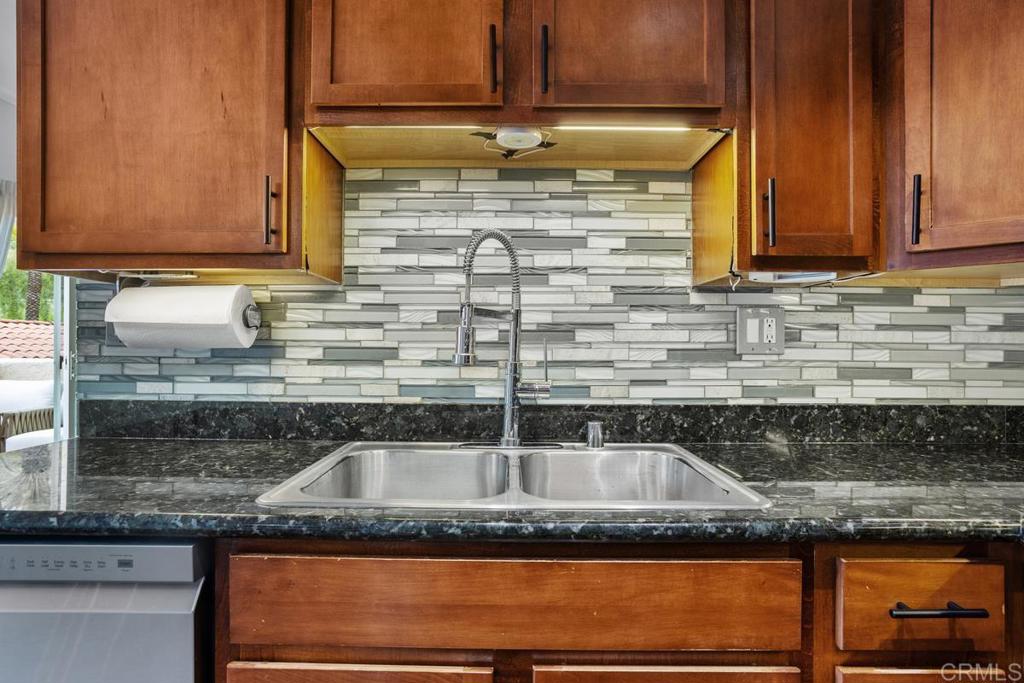 102 Sea Cliff Way Oceanside, CA 92056 - Photo 14 of 44 a kitchen with granite countertop a sink and cabinets