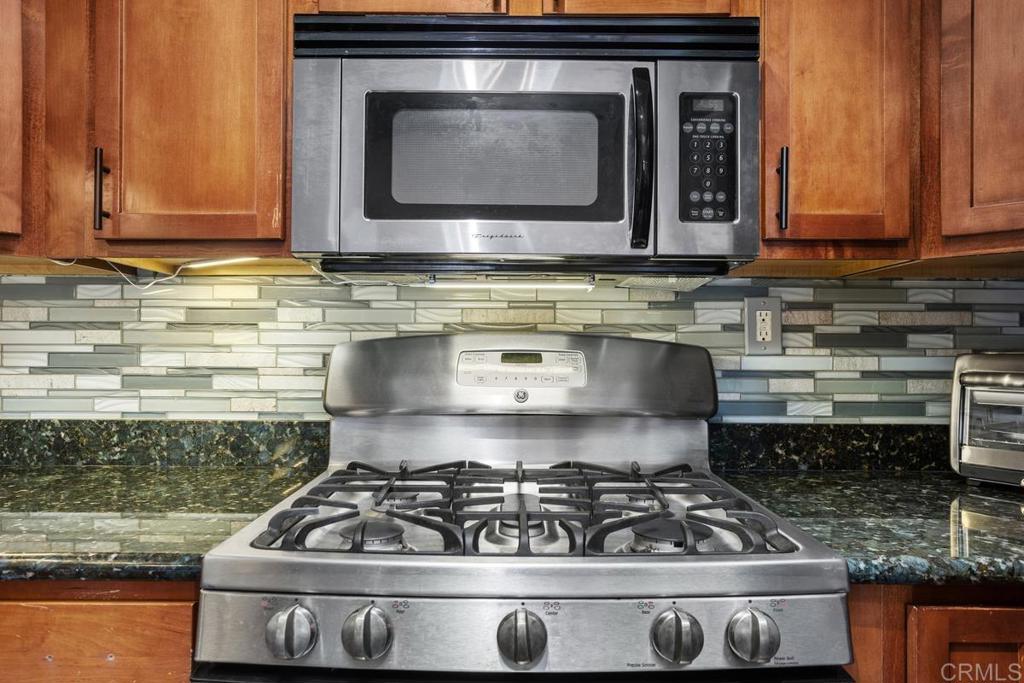 102 Sea Cliff Way Oceanside, CA 92056 - Photo 15 of 44 a stove top oven sitting inside of a kitchen