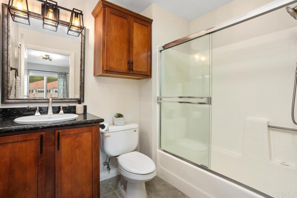 102 Sea Cliff Way Oceanside, CA 92056 - Photo 22 of 44 a bathroom with a granite countertop sink toilet and shower