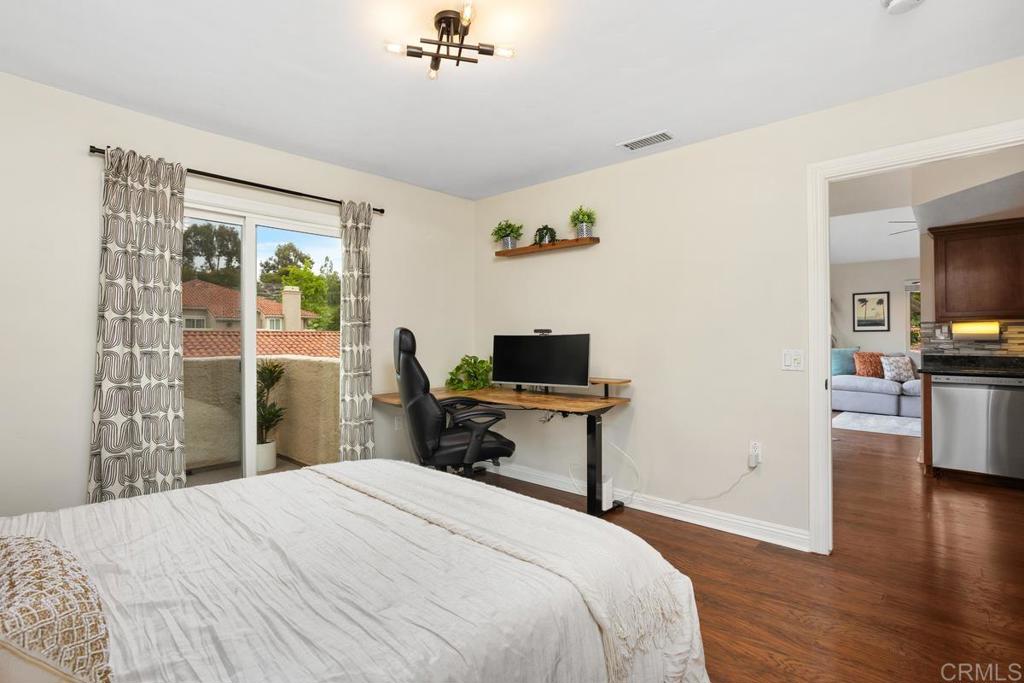 102 Sea Cliff Way Oceanside, CA 92056 - Photo 25 of 44 a bedroom that has a bed and a chair in it