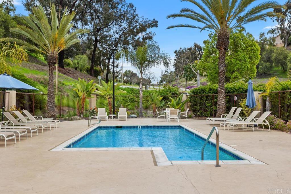 102 Sea Cliff Way Oceanside, CA 92056 - Photo 34 of 44 a view of a swimming pool with a lounge chairs
