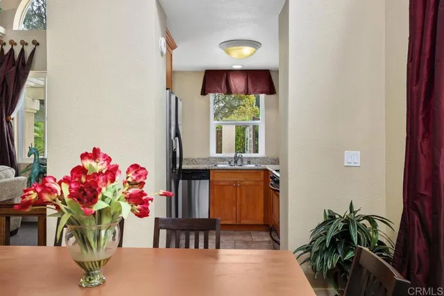 a view of a dining room with furniture and a potted plant