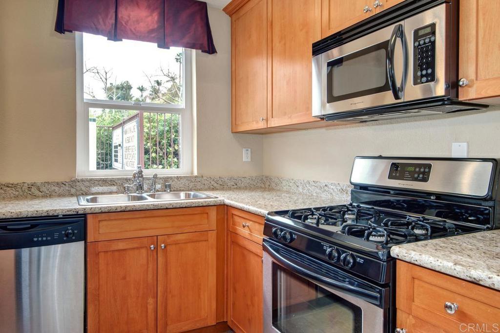 102 Sea Cliff Way Oceanside, CA 92056 - Photo 39 of 44 a kitchen with stainless steel appliances granite countertop a stove sink and cabinets