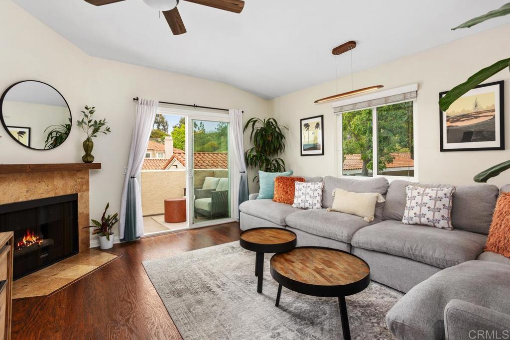102 Sea Cliff Way Oceanside, CA 92056 - Photo 4 of 44 a living room with furniture a fireplace and a large window