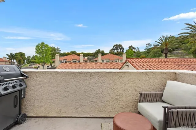 a view of patio with couches and a potted plant
