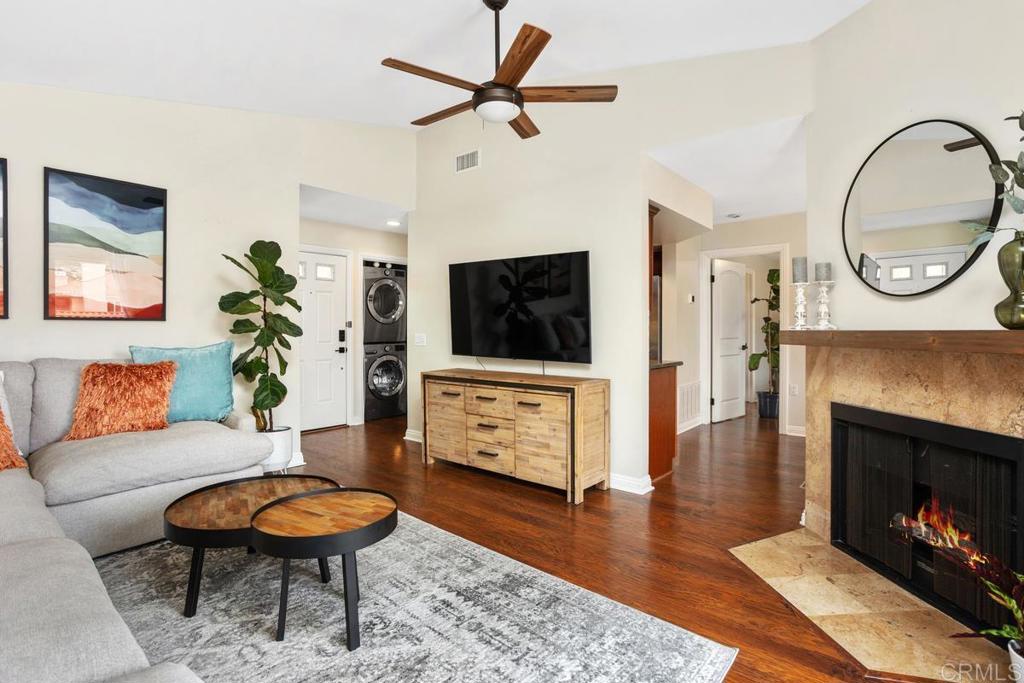 102 Sea Cliff Way Oceanside, CA 92056 - Photo 9 of 44 a living room with furniture a flat screen tv and a fireplace