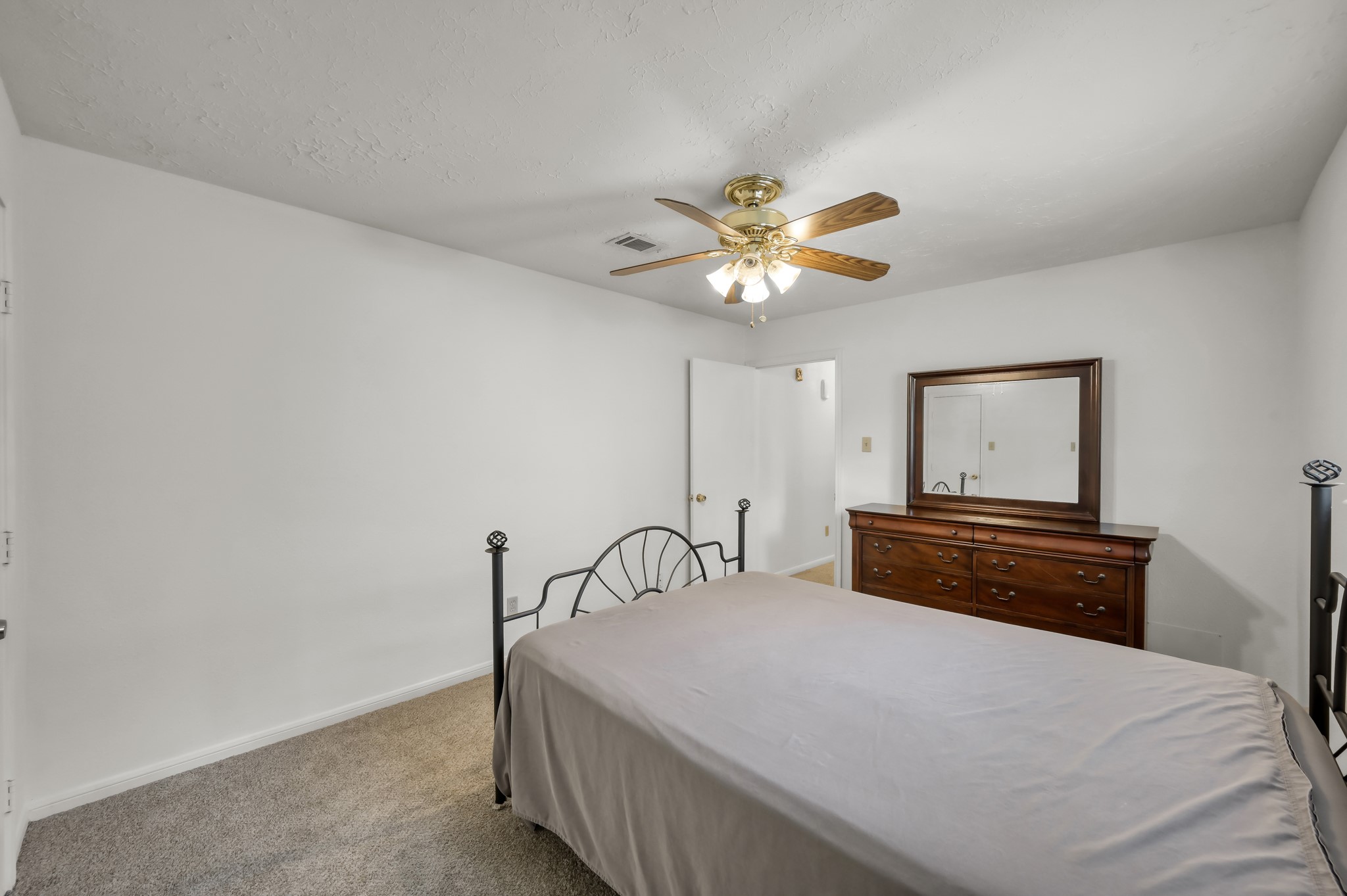 4314 Enchantedgate Drive Spring, TX 77373 - Photo 34 of 47 Guest bedroom features a ceiling fan, neutral walls, and carpeted floors.