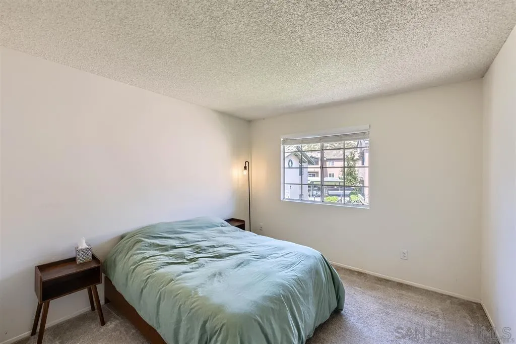 17161 Alva Road, Unit 221 San Diego, CA 92127 - Photo 14 of 26 a bedroom with a bed and a window