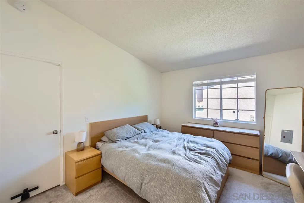 17161 Alva Road, Unit 221 San Diego, CA 92127 - Photo 15 of 26 a bedroom with a bed and a window