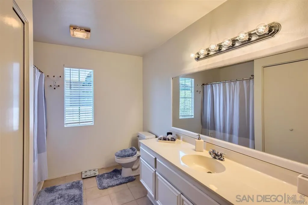 17161 Alva Road, Unit 221 San Diego, CA 92127 - Photo 19 of 26 a bathroom with a tub sink and mirror
