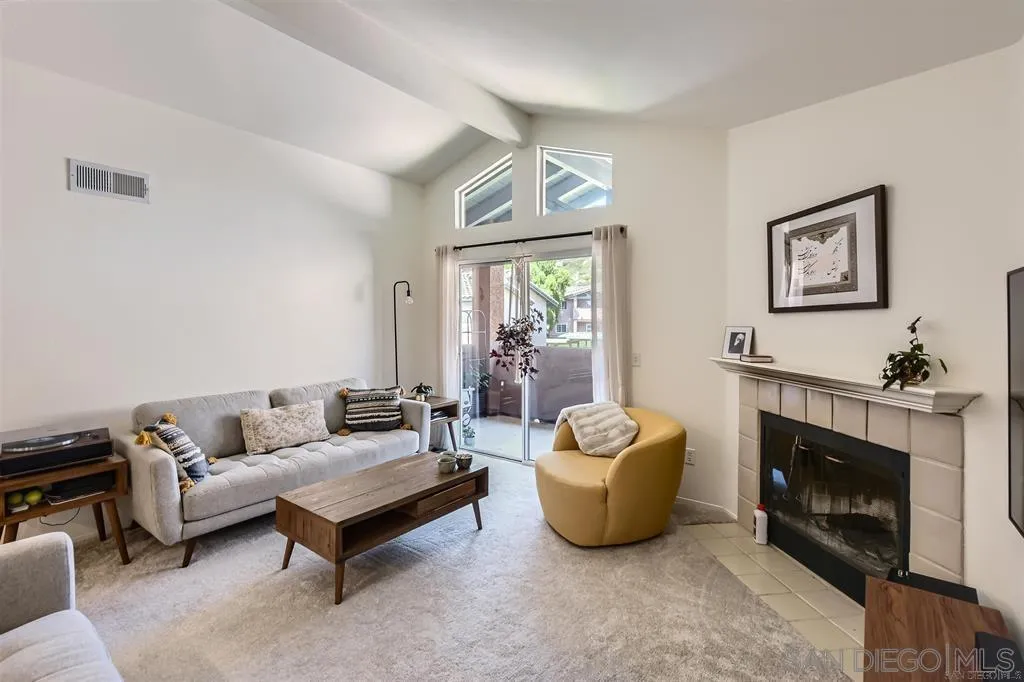 17161 Alva Road, Unit 221 San Diego, CA 92127 - Photo 10 of 26 a living room with furniture a window and a fireplace