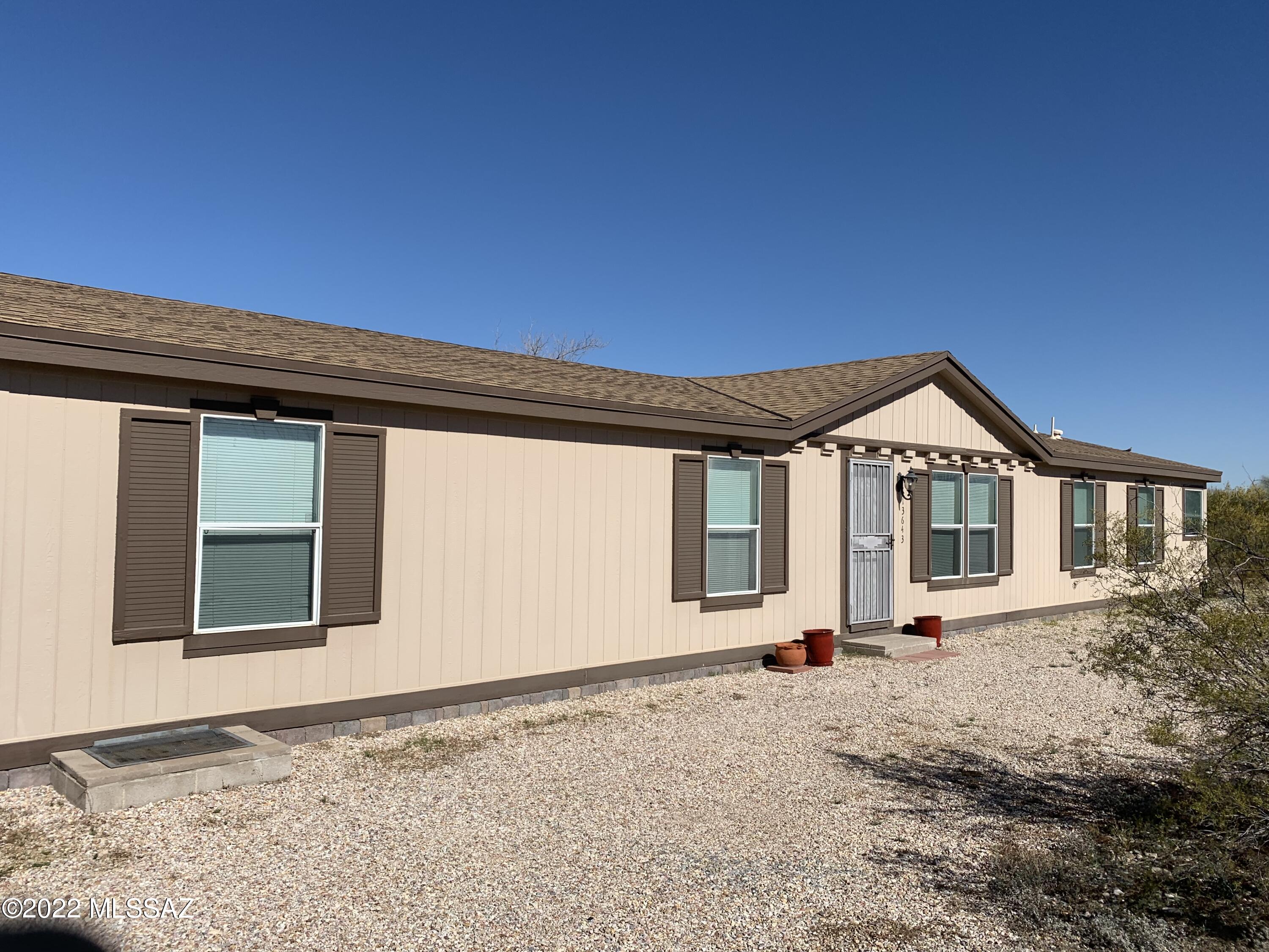 13643 East Bright Sky Loop Vail, AZ 85641 - Photo 1 of 22 a front view of a house with a yard