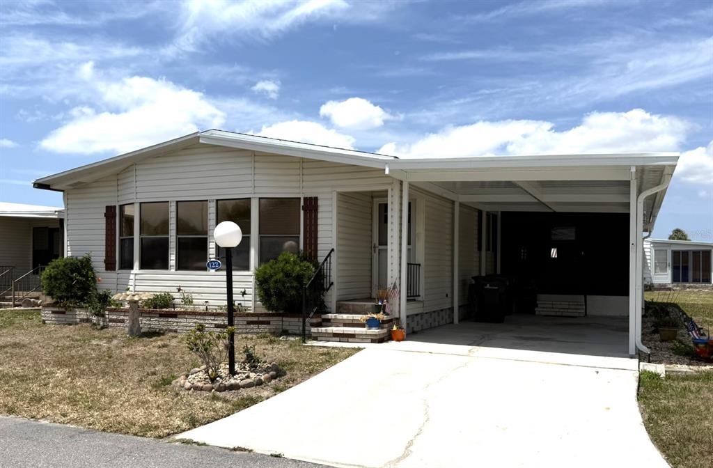 a front view of a house with porch and furniture
