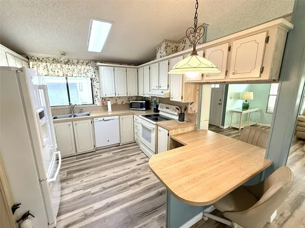 a kitchen with a white stove top oven sink and window