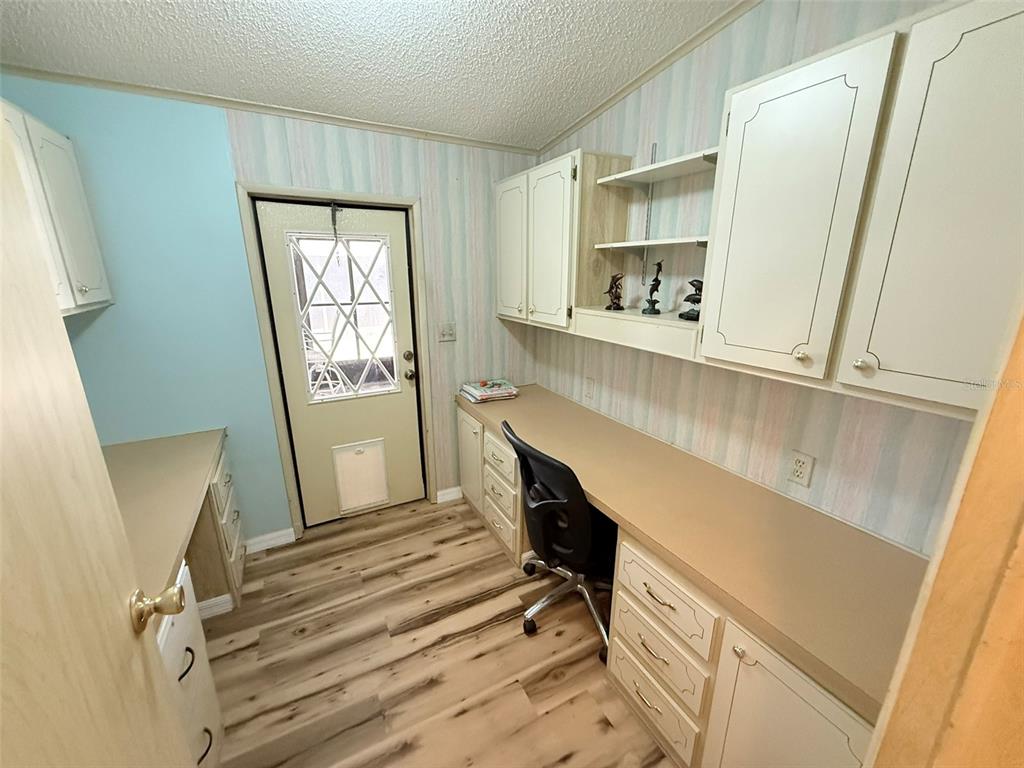 122 Rarotonga Road North Port, FL 34287 - Photo 16 of 48 a view of kitchen with cabinets and wooden floor