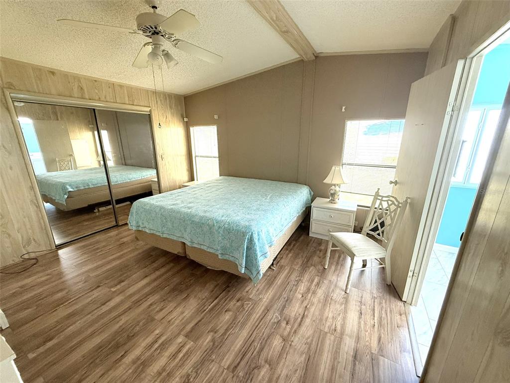 122 Rarotonga Road North Port, FL 34287 - Photo 17 of 48 a bedroom with a bed and a mirror