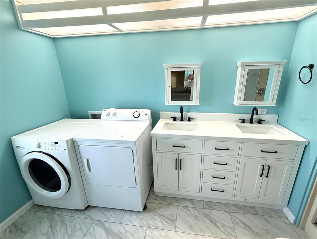 122 Rarotonga Road North Port, FL 34287 - Photo 19 of 48 a utility room with dryer and washer