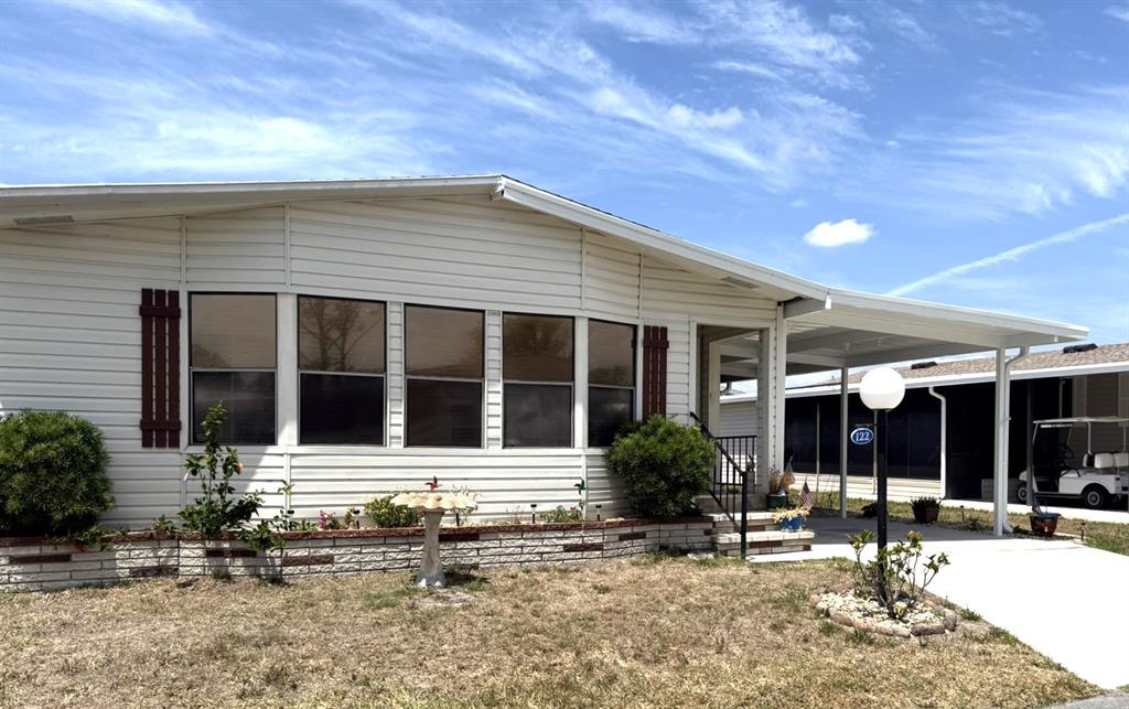 122 Rarotonga Road North Port, FL 34287 - Photo 2 of 48 front view of a house with a patio