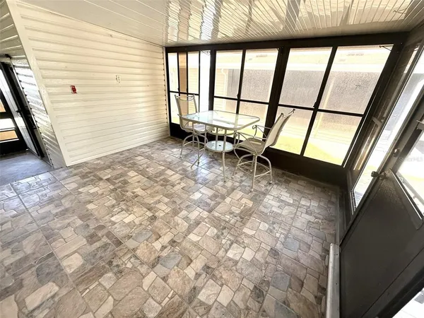a view of an empty room with large windows