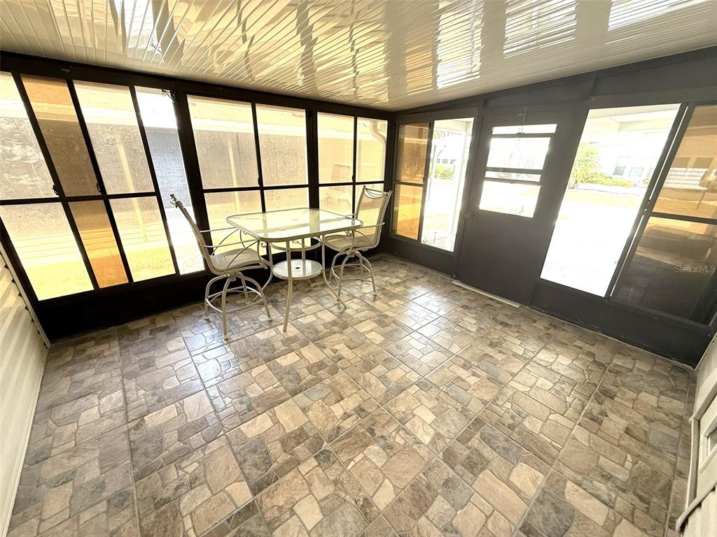 122 Rarotonga Road North Port, FL 34287 - Photo 26 of 48 a view of an empty room with large windows