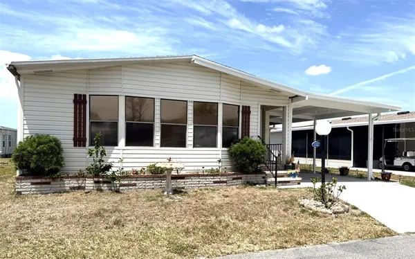 a front view of a house with a sitting area